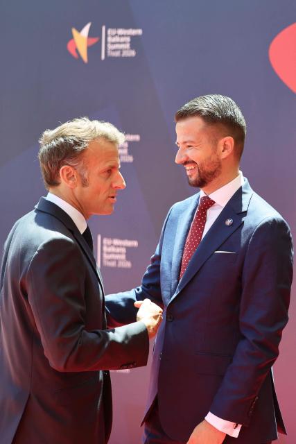 Montenegrin President Jakov Milatovic (R) shakes hands with French President Emmanuel Macron (L) ahead of the EU-Western Balkans Summit at Porto Montenegro in Tivat on June 5, 2026. The summit brings together leaders from EU member states and the six Western Balkans partners to discuss enlargement and gradual integration into the EU single market. (Photo by Ludovic MARIN / AFP)