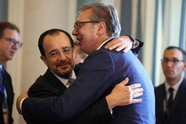 Cypriot President Nikos Christodoulides (L) embraces Serbian President Aleksandar Vucic (R) ahead of the EU-Western Balkans Summit at Porto Montenegro in Tivat on June 5, 2026. The summit brings together leaders from EU member states and the six Western Balkans partners to discuss enlargement and gradual integration into the EU single market. (Photo by Ludovic MARIN / AFP)