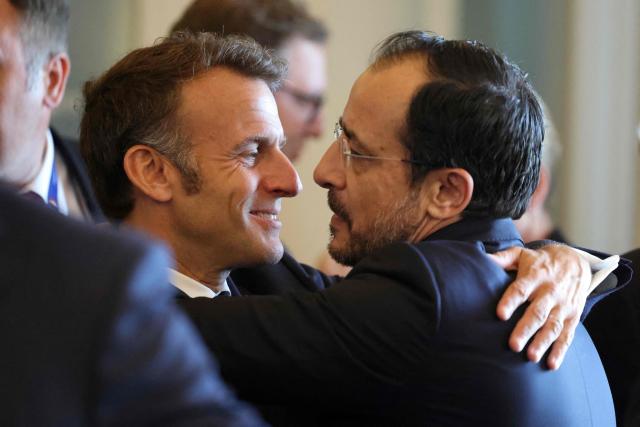 French President Emmanuel Macron (L) embraces Cypriot President Nikos Christodoulides (R) ahead of the EU-Western Balkans Summit at Porto Montenegro in Tivat on June 5, 2026. The summit brings together leaders from EU member states and the six Western Balkans partners to discuss enlargement and gradual integration into the EU single market. (Photo by Ludovic MARIN / AFP)
