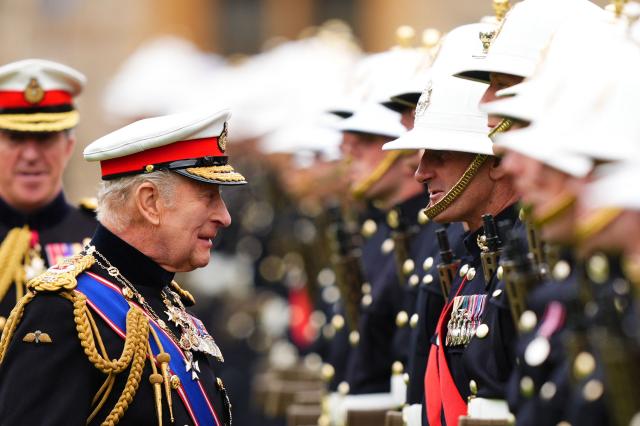 Britain's King Charles III, Captain General Royal Marines, accompanied by First Sea Lord and Commandant General Royal Marines, General Sir Gwyn Jenkins (L) during a ceremony for the presentation of New Colours to the 40, 42, 43 and 45 Commando Royal Marines, at Windsor Castle, June 5, 2026. (Photo by Aaron Chown / POOL / AFP)