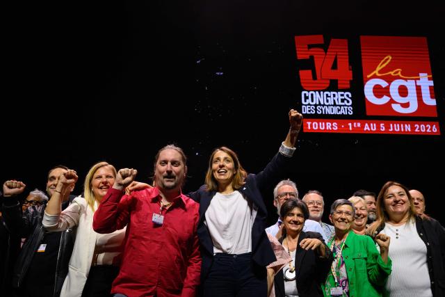CGT leader Sophie Binet (C-R) celebrates on stage after being re-elected as General Secretary during the 54th congress of the General Confederation of Labour (CGT) French trade union in Tours, central France, on June 5, 2026. (Photo by Loic VENANCE / AFP)