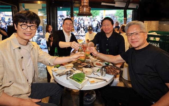 Nvidia CEO Jensen Huang (R) raises a toast with SK Group Chairman Chey Tae-won (2nd R), LG Group Chairman Koo Kwang-mo (2nd L) and Naver founder and chairman Lee Hae-jin (L) during a dinner at a Korean barbecue restaurant in Seoul on June 5, 2026. Nvidia chief executive Jensen Huang arrived in Seoul on June 5, for a packed schedule of meetings with tech leaders, promising "some surprises" for South Korea while predicting robotics will be the country's next major growth sector. (Photo by POOL / AFP)