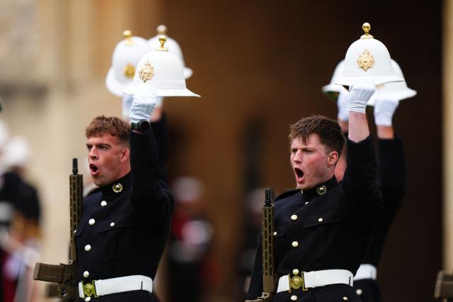 Royal Marines perform a royal salute during a ceremony for the presentation of New Colours to the 40, 42, 43 and 45 Commando Royal Marines, at Windsor Castle, June 5, 2026. (Photo by Aaron Chown / POOL / AFP)
