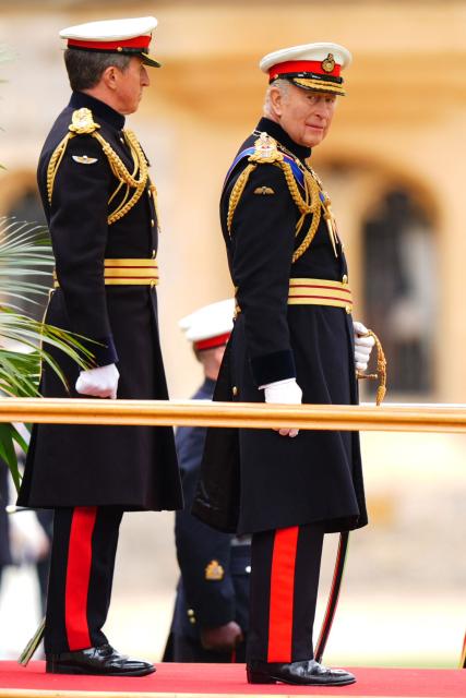 Britain's King Charles III, Captain General Royal Marines, accompanied by First Sea Lord and Commandant General Royal Marines, General Sir Gwyn Jenkins (L) during a ceremony for the presentation of New Colours to the 40, 42, 43 and 45 Commando Royal Marines, at Windsor Castle, June 5, 2026. (Photo by Aaron Chown / POOL / AFP)