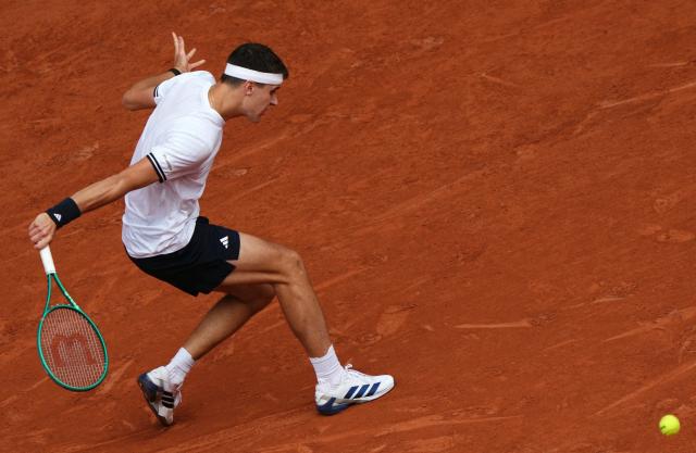 Czech Republic's Jakub Mensik plays a backhand return to Germany's Alexander Zverev during their men's semi final singles match on day 13 of the French Open tennis tournament on Court Philippe-Chatrier at the Roland-Garros Complex in Paris on June 5, 2026. (Photo by Dimitar DILKOFF / AFP)