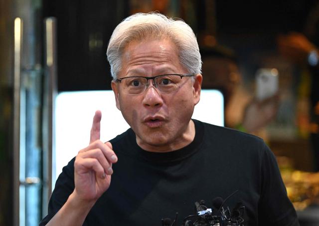 Nvidia CEO Jensen Huang speaks to reporters during a dinner with SK Group Chairman Chey Tae-won, LG Group Chairman Koo Kwang-mo and Naver founder and Chairman Lee Hae-jin at a Korean barbecue restaurant in Seoul on June 5, 2026. Nvidia chief executive Jensen Huang arrived in Seoul on June 5, for a packed schedule of meetings with tech leaders, promising "some surprises" for South Korea while predicting robotics will be the country's next major growth sector. (Photo by Jung Yeon-je / AFP)