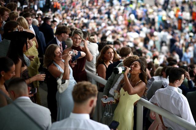 A racegoer poses for a picture on Ladies Day and the opening day of the Epsom Derby Festival horse racing event in Surrey, southern England on June 5, 2026. Held at numerous racecourses across the UK, Ladies Day combines horse racing with a celebration of female fashion (Photo by Henry Nicholls / AFP)