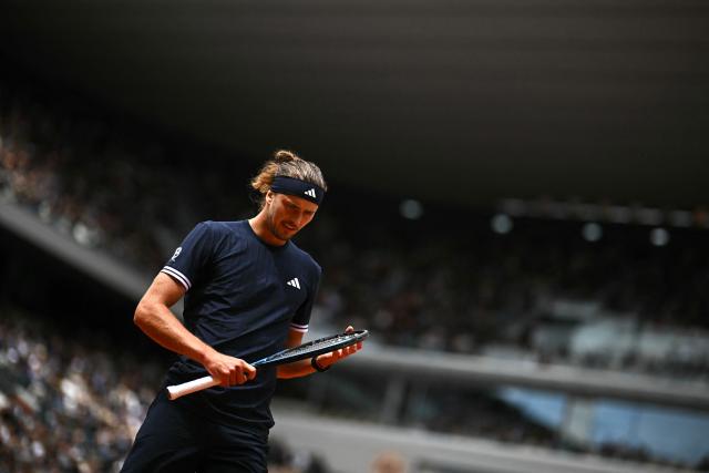 Germany's Alexander Zverev cehcks his racket as he plays against Czech Republic's Jakub Mensik during their men's semi final singles match on day 13 of the French Open tennis tournament on Court Philippe-Chatrier at the Roland-Garros Complex in Paris on June 5, 2026. (Photo by JULIEN DE ROSA / AFP)