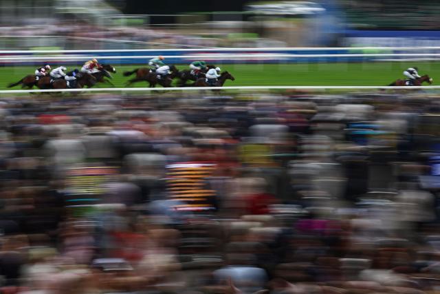 Jockey Sam James rides Hickory Lad (R) to victory in the Woodcote Staes on the opening day of the Epsom Derby Festival horse racing event in Surrey, southern England on June 5, 2026. (Photo by Henry Nicholls / AFP)