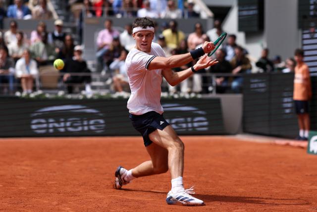 Czech Republic's Jakub Mensik plays a backhand return to Germany's Alexander Zverev during their men's semi final singles match on day 13 of the French Open tennis tournament on Court Philippe-Chatrier at the Roland-Garros Complex in Paris on June 5, 2026. (Photo by Alain JOCARD / AFP)
