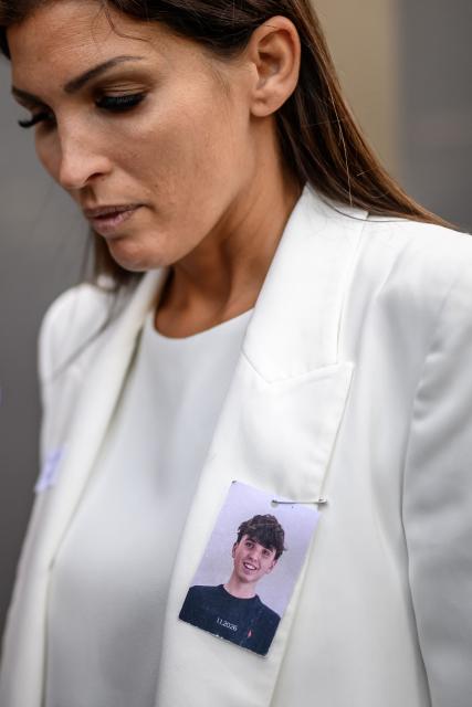 Laetitia Brodard-Sitre, bearing on her white jacket a photograph of her late son Arthur who died in the fire, reacts during a hearing of owners of Le Constellation bar in Crans-Montana as part of the inquiry into a devastating New Year's fire, that killed 41 people, mostly teenagers, and injured 115 others, in Sion on June 5, 2026. (Photo by Fabrice COFFRINI / AFP)