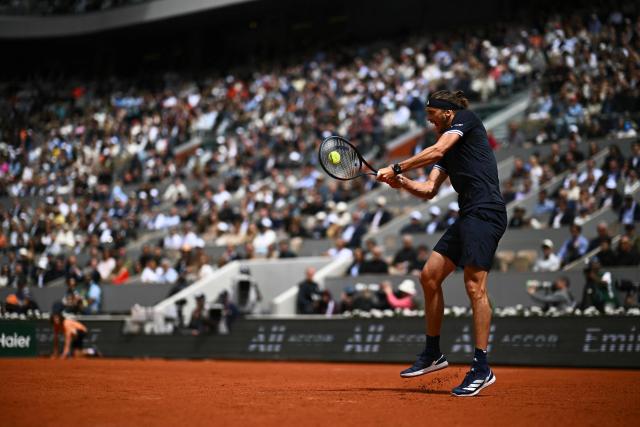 Germany's Alexander Zverev plays a backhand return to Czech Republic's Jakub Mensik during their men's semi final singles match on day 13 of the French Open tennis tournament on Court Philippe-Chatrier at the Roland-Garros Complex in Paris on June 5, 2026. (Photo by JULIEN DE ROSA / AFP)