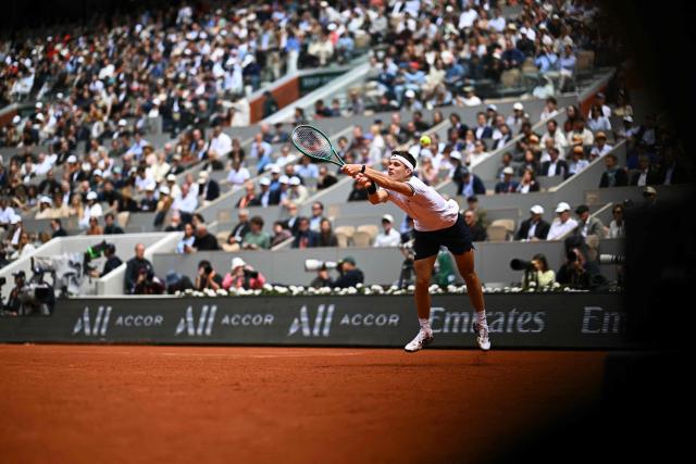 Czech Republic's Jakub Mensik plays a backhand return to Germany's Alexander Zverev during their men's semi final singles match on day 13 of the French Open tennis tournament on Court Philippe-Chatrier at the Roland-Garros Complex in Paris on June 5, 2026. (Photo by JULIEN DE ROSA / AFP)