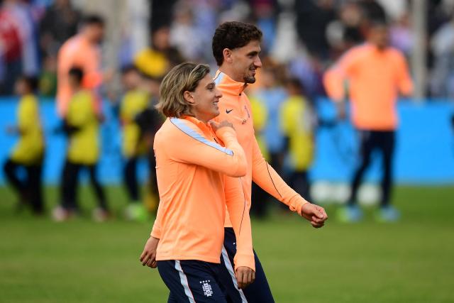 Uruguay's midfielder Agustin Canobio (L) and defender Santiago Bueno take part in a farewell activity with children ahead of the departure of the sqad for the FIFA World Cup 2026, at the Tito LOpez Lopez stadium in Pando, Canelones department, Uruguay on June 5, 2026. (Photo by Dante FERNANDEZ / AFP)