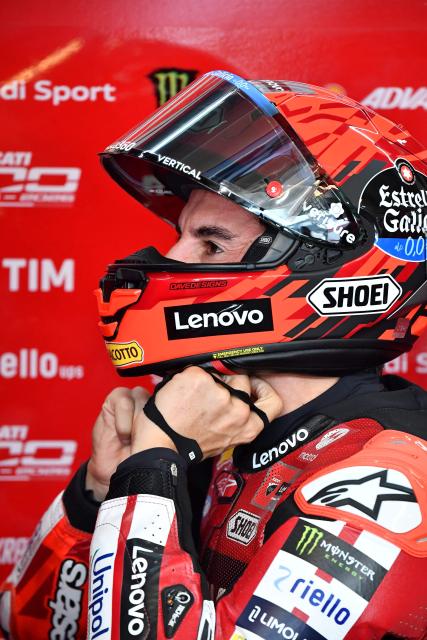 Ducati Lenovo Team's Marc Marquez puts on his helmet prior to the Practice session at the Balaton Park Circuit in Balatonfokajar, Hungary, on June 5, 2026, ahead of the Hungarian Motorcycle MotoGP Grand Prix. (Photo by FERENC ISZA / AFP)
