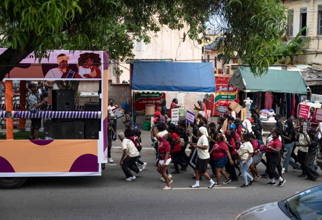 Protesters march behind a bus during a march for peace and family diversity organised by a coalition of feminist and human rights organisations in Accra on June 5, 2026. The march came a week after Ghana's parliament passed a controversial anti-LGBTQ bill that would further restrict LGBTQ rights and criminalise the promotion of LGBTQ activities. Demonstrators also protested against the fourth Pan-African Conference on Family Values, currently held for the first time in Accra. (Photo by Claudia LACAVE / AFP)