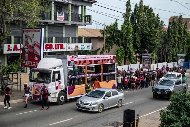 Protesters march behind a bus during a march for peace and family diversity organised by a coalition of feminist and human rights organisations in Accra on June 5, 2026. The march came a week after Ghana's parliament passed a controversial anti-LGBTQ bill that would further restrict LGBTQ rights and criminalise the promotion of LGBTQ activities. Demonstrators also protested against the fourth Pan-African Conference on Family Values, currently held for the first time in Accra. (Photo by Claudia LACAVE / AFP)