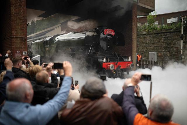 The Flying Scotsman steam locomotive travels along the East Lancashire Railway's line as it departs Bolton Street Station in Bury, northern England on June 5, 2026. The Flying Scotsman was built in 1923 and holds the record for becoming the first steam locomotive to be officially authenticated at reaching 100 miles per hour on November 30, 1934. Following a 4.2 million GBP refurbishment, the Flying Scotsman returned to the UK's mainline in 2016. The East Lancashire Railway runs a 12 mile heritage railway line between the stations of Heywood and Rawtenstall. (Photo by Oli SCARFF / AFP)