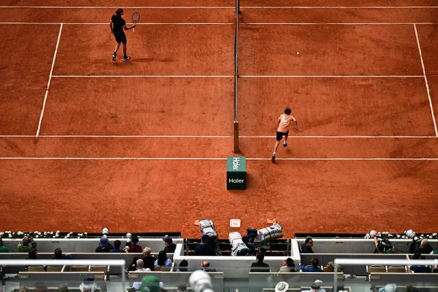 Germany's Alexander Zverev reacts as he bBall Kid run towrds a tennis ball during his men's semi final singles match against Czech Republic's Jakub Mensik on day 13 of the French Open tennis tournament on Court Philippe-Chatrier at the Roland-Garros Complex in Paris on June 5, 2026. (Photo by JULIEN DE ROSA / AFP)