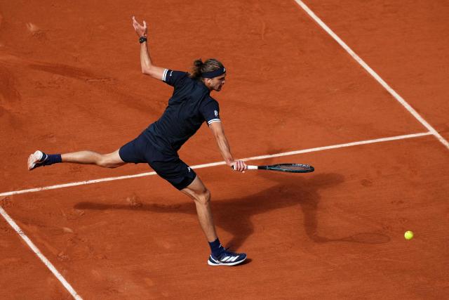 Czech Republic's Jakub Mensik plays a backhand return to Germany's Alexander Zverev during their men's semi final singles match on day 13 of the French Open tennis tournament on Court Philippe-Chatrier at the Roland-Garros Complex in Paris on June 5, 2026. (Photo by Dimitar DILKOFF / AFP)
