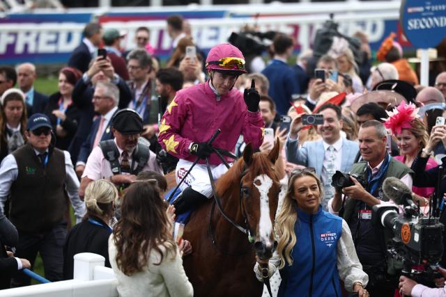 Jockey Dylan Browne McMonagle returns to the winner's enclosure after winning The Oaks on Thundering On to victory on the opening day of the Epsom Derby Festival horse racing event in Surrey, southern England on June 5, 2026. (Photo by Henry NICHOLLS / AFP)