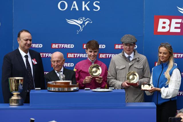 Jockey Dylan Browne McMonagle (C) and trainer joseph patrick O'Brien (2R) pose with their trophies at the presentation ceremony after Thundering On wins The Oaks on the opening day of the Epsom Derby Festival horse racing event in Surrey, southern England on June 5, 2026. (Photo by Henry NICHOLLS / AFP)