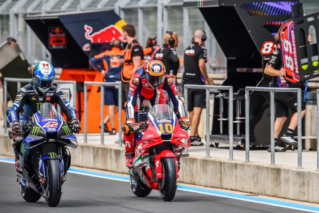 Team Monster Energy Yamaha MotoGP's Alex Rins (L) and Team Repsol Honda Team's Luca Marini arrive in the pit lane during the Practice session at the Balaton Park Circuit in Balatonfokajar, Hungary, on June 5, 2026, ahead of the Hungarian Motorcycle MotoGP Grand Prix. (Photo by FERENC ISZA / AFP)