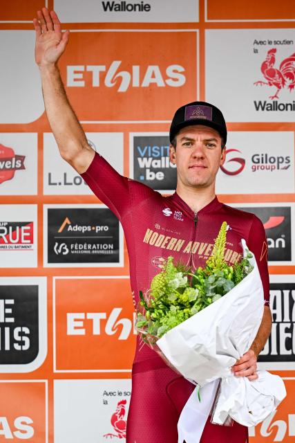 Modern Adventure Pro Cycling's New Zealand celebrates on the podium after winning the fifth stage of the Tour De Wallonie cycling race, 176,4 km from Bassenge to Aubel on June 5, 2026. (Photo by DAVID PINTENS / Belga / AFP) / Belgium OUT