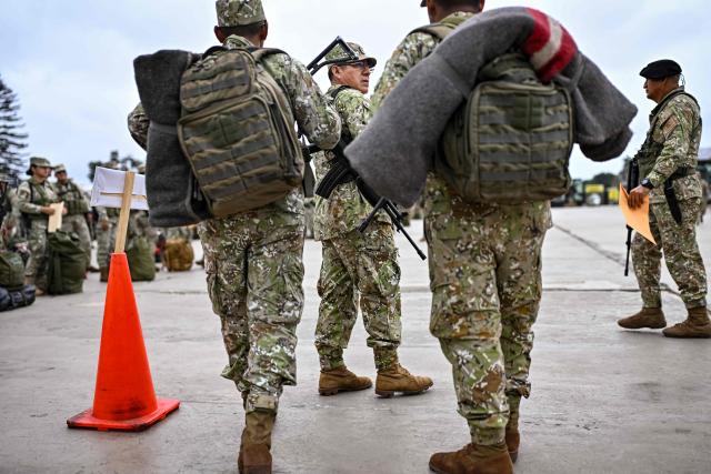 Army soldiers prepare to board buses to be deployed to polling stations to provide security and safeguard electoral materials in Lima on June 5, 2026, ahead of the presidential election runoff. Right-wing candidate Keiko Fujimori and leftist Roberto Sanchez will face off in Peru's presidential runoff on June 7, 2026. (Photo by MARTIN BERNETTI / AFP)