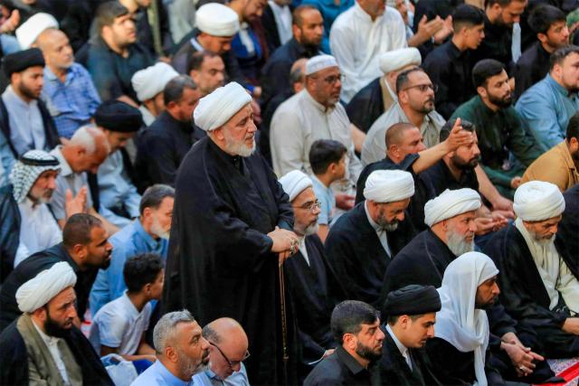 Mourners attend the funeral of Iraqi Shia Muslim cleric and Grand Ayatollah Mohammad Ishaq al-Fayyad by the shrines of Imam Hussein and Abbas in Iraq's central holy city of Karbala on June 5, 2026. (Photo by Karrar Jabbar / AFP)
