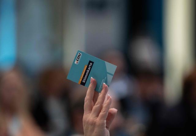 An unidentified delegate of the Christian Democratic Union (CDU) in Mecklenburg–Western Pomerania votes by a show of hands at the 41st CDU Mecklenburg–Western Pomerania Party Congress in Linstow, on June 5, 2026. (Photo by John MACDOUGALL / AFP)