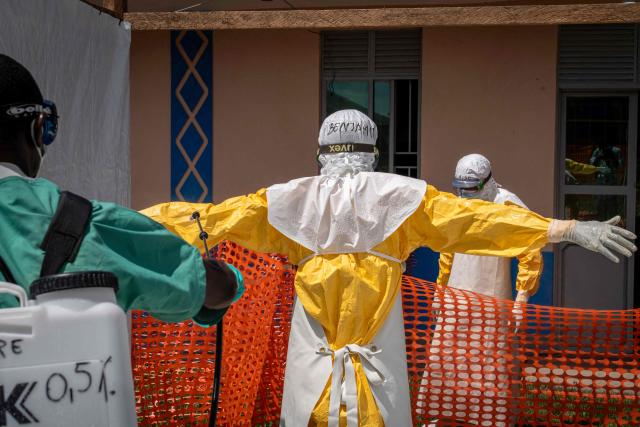 A member of the Doctors Without Border (MSF) personnel at the Elikya clinic Ebola treatment center his sprayed as he prepares to remove his personal protection equipment (PPE) in Bunia, in the eastern Democratic Republic of the Congo, on June 5, 2026. (Photo by GLODY MURHABAZI / AFP)