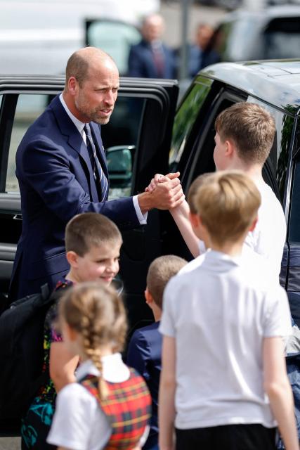 Britain's Prince William, Prince of Wales, is greeted by children after meeting with serving submariners and their families at Drumfork Centre on the Churchill Estate on June 2, 2026 in Helensburgh, Scotland. Prince Wlliam, Prince of Wales, of Wales, Commodore-in-Chief of the Submarine Service, visited HM Naval Base Clyde (also known as Faslane) to mark the 125th anniversary of the Royal Navy's Submarine Service. (Photo by Jeff J Mitchell / POOL / AFP)