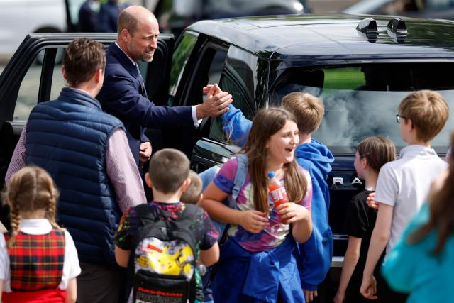 Britain's Prince William, Prince of Wales, is greeted by children after meeting with serving submariners and their families at Drumfork Centre on the Churchill Estate on June 2, 2026 in Helensburgh, Scotland. Prince Wlliam, Prince of Wales, of Wales, Commodore-in-Chief of the Submarine Service, visited HM Naval Base Clyde (also known as Faslane) to mark the 125th anniversary of the Royal Navy's Submarine Service. (Photo by Jeff J Mitchell / POOL / AFP)
