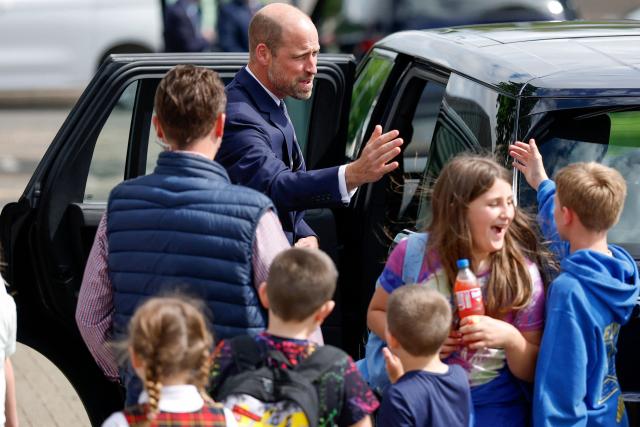 Britain's Prince William, Prince of Wales, is greeted by children after meeting with serving submariners and their families at Drumfork Centre on the Churchill Estate on June 2, 2026 in Helensburgh, Scotland. Prince Wlliam, Prince of Wales, of Wales, Commodore-in-Chief of the Submarine Service, visited HM Naval Base Clyde (also known as Faslane) to mark the 125th anniversary of the Royal Navy's Submarine Service. (Photo by Jeff J Mitchell / POOL / AFP)