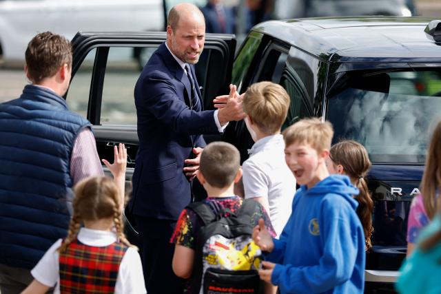 Britain's Prince William, Prince of Wales, is greeted by children after meeting with serving submariners and their families at Drumfork Centre on the Churchill Estate on June 2, 2026 in Helensburgh, Scotland. Prince Wlliam, Prince of Wales, of Wales, Commodore-in-Chief of the Submarine Service, visited HM Naval Base Clyde (also known as Faslane) to mark the 125th anniversary of the Royal Navy's Submarine Service. (Photo by Jeff J Mitchell / POOL / AFP)