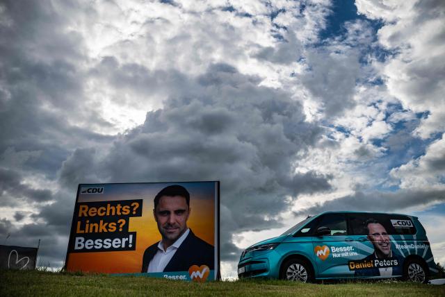 A billboard featuring leader of the Christian Democratic Union (CDU) in Mecklenburg–Western Pomerania and main candidate in upcoming state elections Daniel Peters as well as a campaign vehicle are seen outside the venue of the 41st CDU Mecklenburg–Western Pomerania Party Congress in Linstow, on June 5, 2026. (Photo by John MACDOUGALL / AFP)