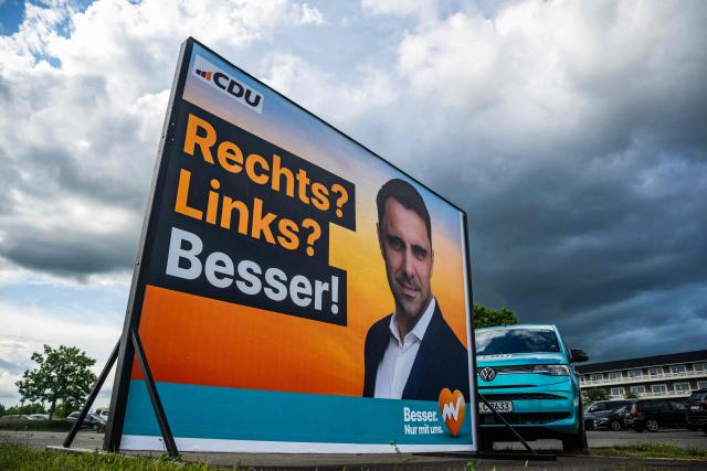 A billboard featuring leader of the Christian Democratic Union (CDU) in Mecklenburg–Western Pomerania and main candidate in upcoming state elections Daniel Peters as well as a campaign vehicle are seen outside the venue of the 41st CDU Mecklenburg–Western Pomerania Party Congress in Linstow, on June 5, 2026. (Photo by John MACDOUGALL / AFP)