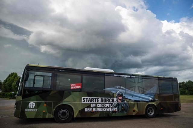 A bus of the German armed forces (Bundeswehr) features an ad for the German air force outside the venue of the 41st CDU Mecklenburg–Western Pomerania Party Congress in Linstow, on June 5, 2026. The ad features a likeness of the Typhoon Eurofighter aircraft and reads: "Get off to a flying start in the cockpit of the Bundeswehr". (Photo by John MACDOUGALL / AFP)