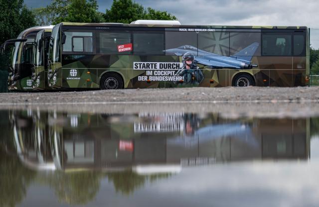 A bus of the German armed forces (Bundeswehr) features an ad for the German air force outside the venue of the 41st CDU Mecklenburg–Western Pomerania Party Congress in Linstow, on June 5, 2026. The ad features a likeness of the Typhoon Eurofighter aircraft and reads: "Get off to a flying start in the cockpit of the Bundeswehr". (Photo by John MACDOUGALL / AFP)