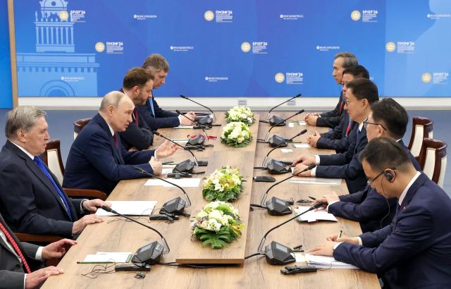 In this pool photograph distributed by the Russian state agency Sputnik, Russia's President Vladimir Putin and Vice President of the People’s Republic of China Han Zheng hold a meeting on the sidelines of the St. Petersburg International Economic Forum (SPIEF) in Saint Petersburg on June 5, 2026. (Photo by Valery SHARIFULIN / POOL / AFP)