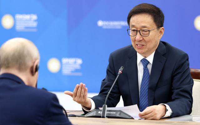 In this pool photograph distributed by the Russian state agency Sputnik, Russia's President Vladimir Putin and Vice President of the People’s Republic of China Han Zheng hold a meeting on the sidelines of the St. Petersburg International Economic Forum (SPIEF) in Saint Petersburg on June 5, 2026. (Photo by Valery SHARIFULIN / POOL / AFP)