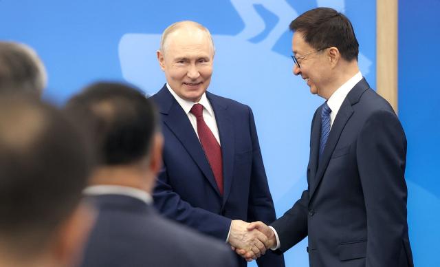In this pool photograph distributed by the Russian state agency Sputnik, Russia's President Vladimir Putin and Vice President of the People’s Republic of China Han Zheng hold a meeting on the sidelines of the St. Petersburg International Economic Forum (SPIEF) in Saint Petersburg on June 5, 2026. (Photo by Valery SHARIFULIN / POOL / AFP)