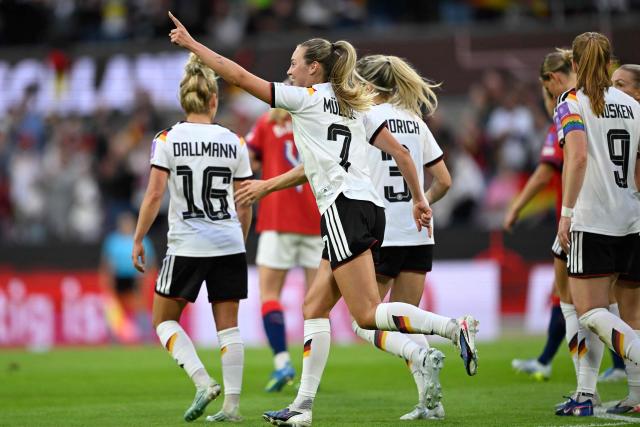 Germany's defender #07 Marie Mueller celebrates scoring the opening goal with her teammates during the Women's FIFA World Cup qualifying football match between Germany and Norway in Cologne, western Germany on June 5, 2026. (Photo by INA FASSBENDER / AFP)