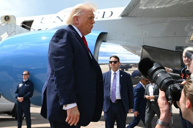 US President Donald Trump speaks to journalists after disembarking Air Force One at Chippewa Valley Regional Airport in Eau Claire, Wisconsin, on June 5, 2026. Trump will participate in a rural economic roundtable on American agriculture in Chippewa Falls. (Photo by SAUL LOEB / AFP)
