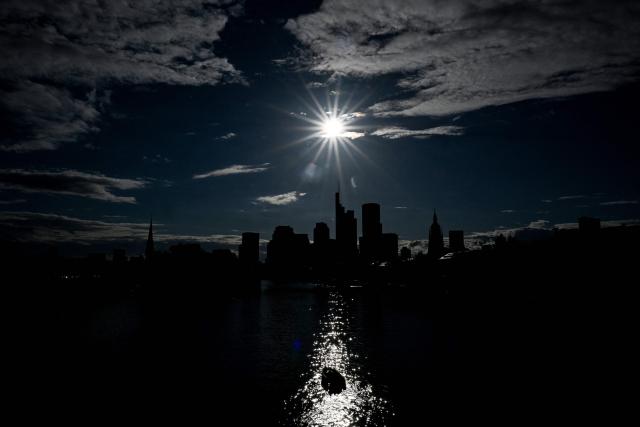 A boat sails on the Main river in front of the banking district skyline with the Commerzbank building (4th R) and the Cathedral (2nd R) during sunset in Frankfurt am Main, western Germany, on June 5, 2026. (Photo by Kirill KUDRYAVTSEV / AFP)