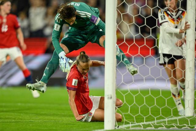Germany's goalkeeper #01 Ann-Katrin Berger jumps over Norway's forward #20 Synne Jensen during the Women's FIFA World Cup qualifying football match between Germany and Norway in Cologne, western Germany on June 5, 2026. (Photo by INA FASSBENDER / AFP)