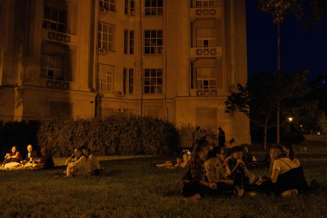 People relax on a warm summer evening in Kyiv on June 5, 2026, amid the Russian invasion of Ukraine. (Photo by Tetiana DZHAFAROVA / AFP)