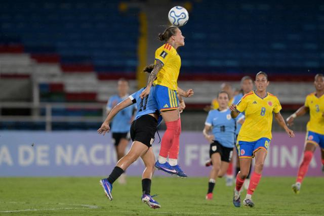 Colombia's defender #04 Ana Guzman heads the ball past Uruguay's forward #11 Esperanza Pizarro during the CONMEBOL Nations League Women football match between Colombia and Uruguay at the Pascual Guerrero stadium in Cali, Valle del Cauca department, Colombia on June 5, 2026. (Photo by JOAQUIN SARMIENTO / AFP)