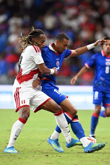 Haiti's forward #18 Wilson Isidor (R) and Peru's forward #18 Andre Carrillo fight for the ball during the international friendly football match between Haiti and Peru at Nu Stadium in Miami, Florida on June 5, 2026. (Photo by CHANDAN KHANNA / AFP)